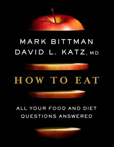 How to Eat Book Cover: black background, red apple sliced horizontally with authors and title written in between the slices