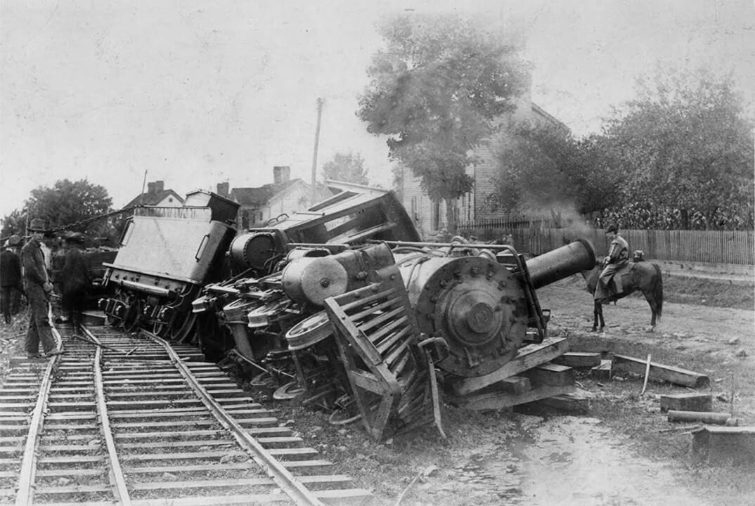 Black and White image of a derailed steam locamotive
